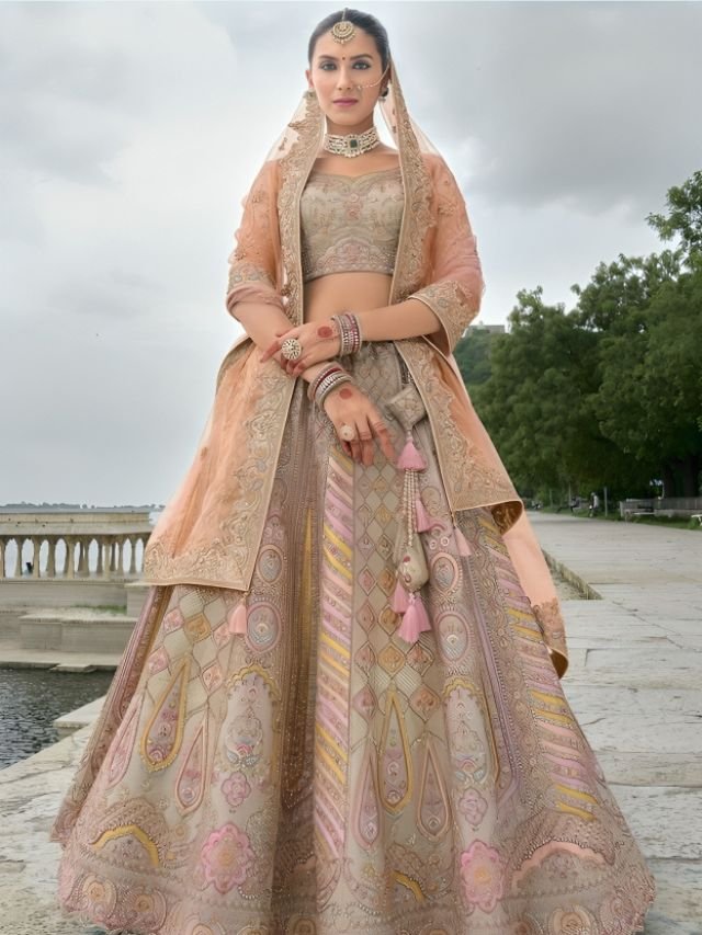 Pin Net Dupatta on the Bun and Wrap the End Parts around Both Hands with lehenga Pin Net Dupatta on the Bun and Wrap the End Parts around Both Hands with lehenga
